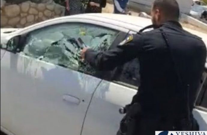 El policía destroza la ventanilla del automóvil para sacar al niño del interior